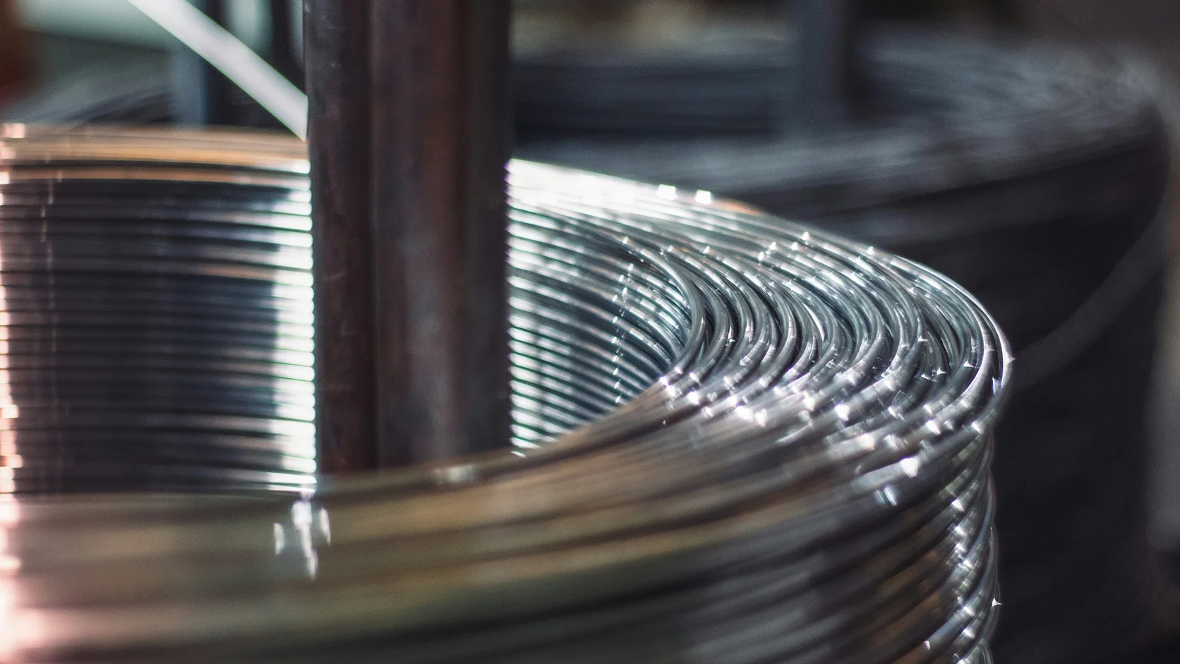 Close-up photograph of smooth steel wire wound around a spindle